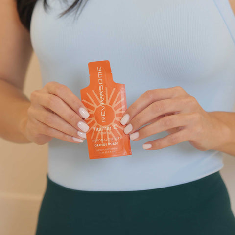 Revival Nutrition Revivasome - Vitamin C Woman holding sachet close